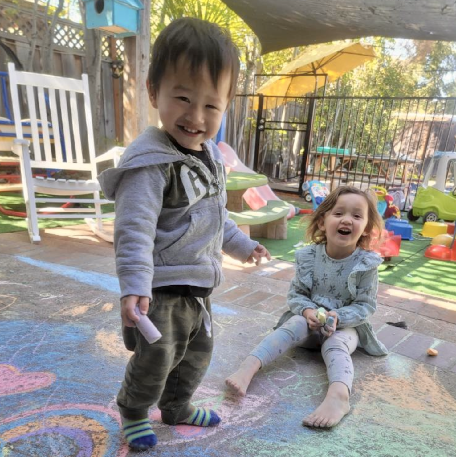 Some of our peek-a-boo daycare children playing with chalk